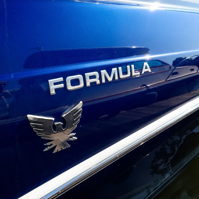 Slide: The Image of 2013 Formula 290 Bowrider boat with logo on blue hull. - 19