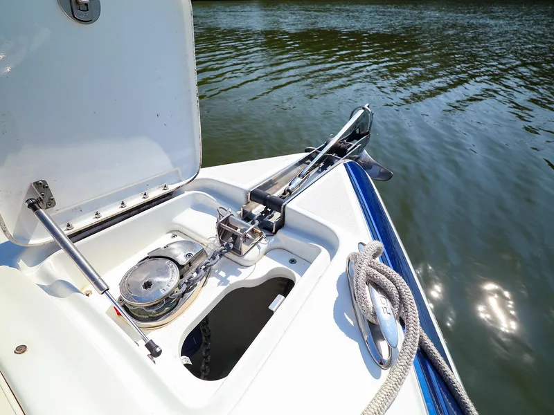 Slide: The Image of 2013 Formula 290 Bowrider anchor compartment with rope and winch by the water. - 25