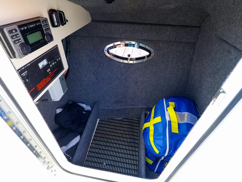 Slide: The Image of 2013 Formula 290 Bowrider cabin interior with radio, window, and blue bag. - 26