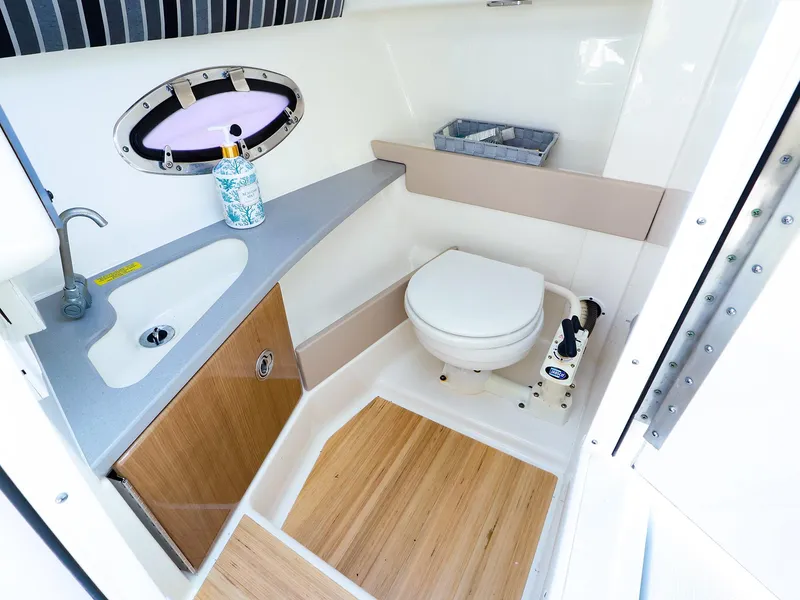 Slide: The Image of 2013 Formula 290 Bowrider bathroom with sink, toilet, and wooden flooring. - 29
