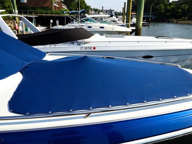 Slide: The Image of 2013 Formula 290 Bowrider with blue cover docked at marina. - 3