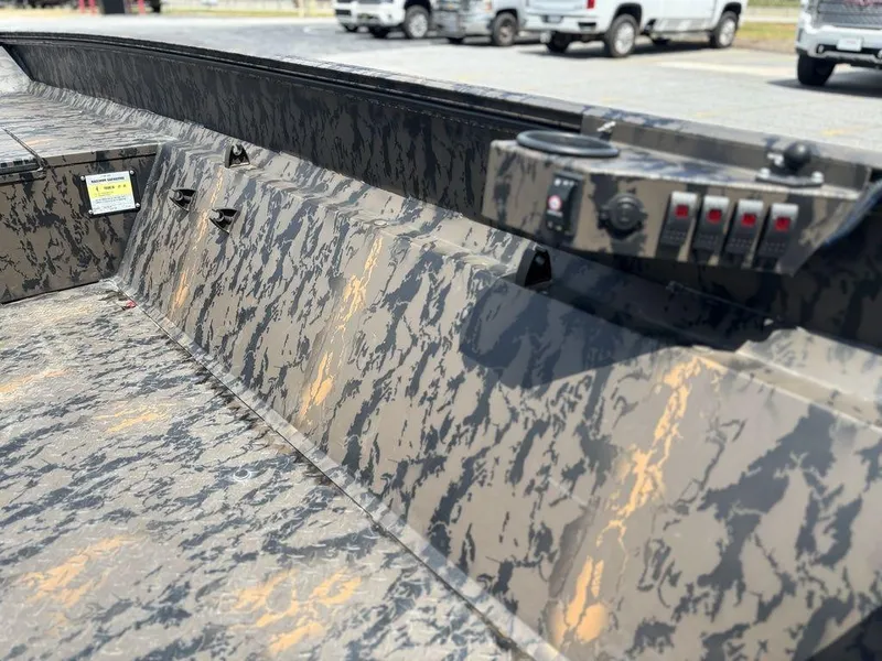 Slide: The Image of 2024 Edge Duck Boats 1756 Diamondback interior with camouflage design and control panel. - 22