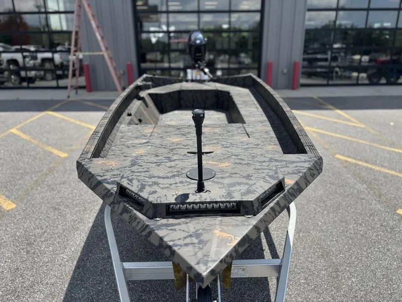 Slide: The Image of 2024 Edge Duck Boats 1756 DIAMONDBACK with camouflage design, parked outdoors. - 6