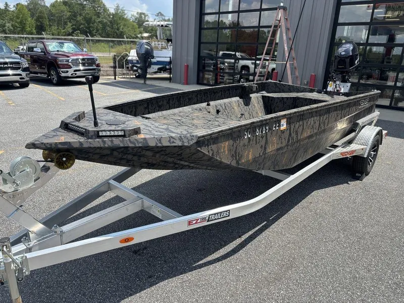 Slide: The Image of 2024 Edge Duck Boats 1756 Diamondback on trailer, parked outdoors near vehicles. - 7