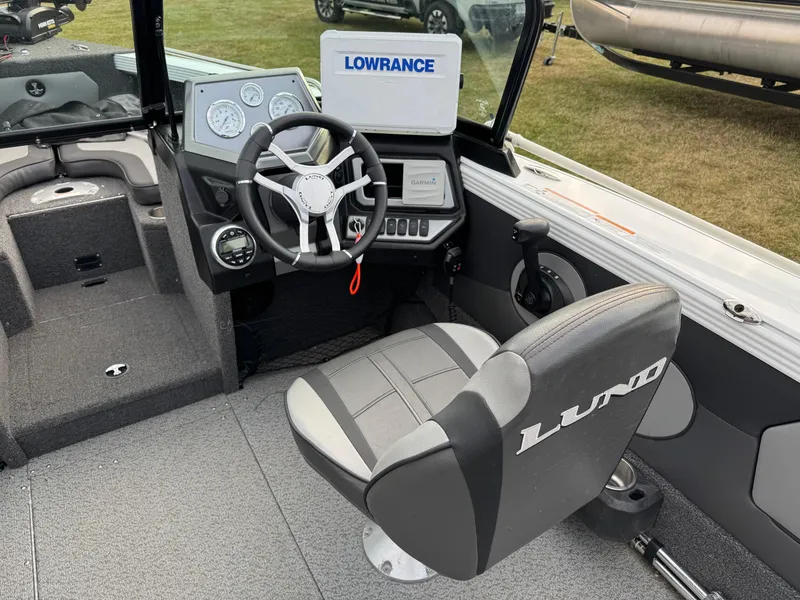 Slide: The Image of 2021 Lund 1875 Tyee boat interior with steering wheel and navigation equipment. - 10