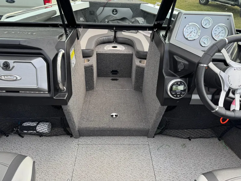 Slide: The Image of 2021 Lund 1875 Tyee boat interior with steering wheel and dashboard gauges. - 14