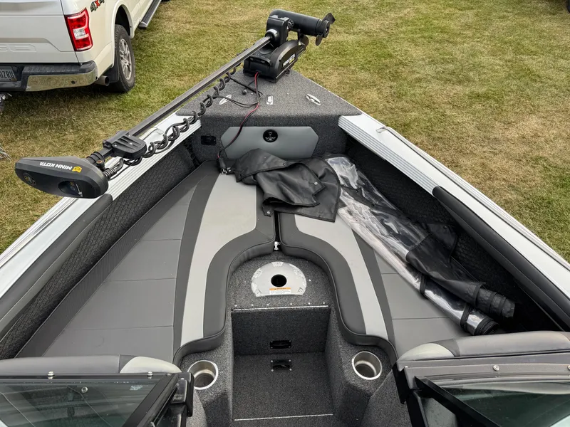 Slide: The Image of 2021 Lund 1875 Tyee boat interior with Minn Kota trolling motor on grass. - 16