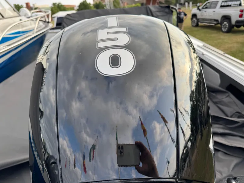 Slide: The Image of Close-up of a 2021 Lund 1875 Tyee boat engine with "150" marking. - 4
