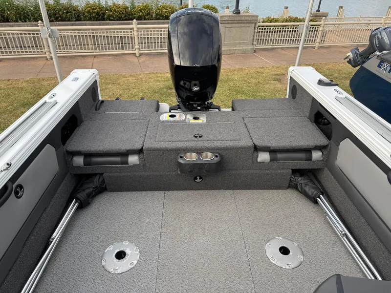 Slide: The Image of 2021 Lund 1875 Tyee boat interior with motor, gray seating, and cup holders. - 6