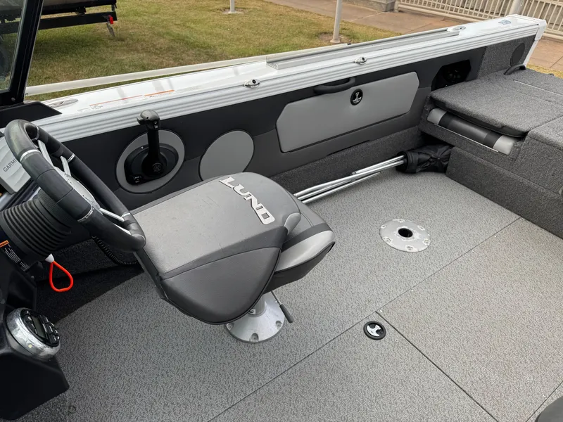 Slide: The Image of 2021 Lund 1875 Tyee boat interior with steering wheel and seating. - 8