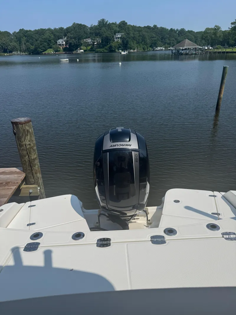 Slide: The Image of 2018 Boston Whaler 210 Dauntless with Mercury engine on calm lake. - 2