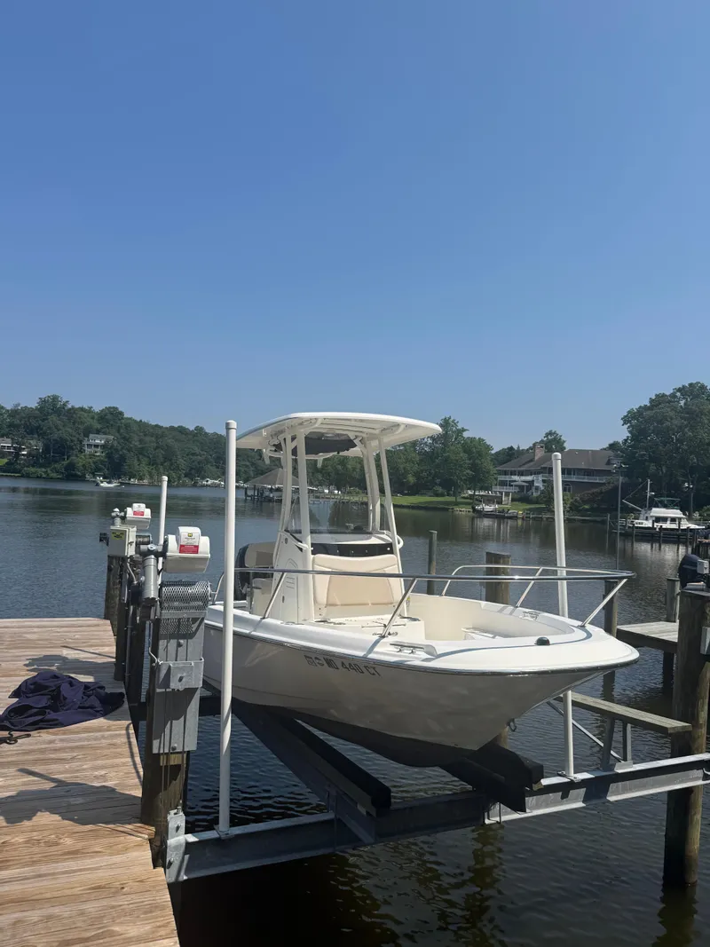 Slide: The Image of 2018 Boston Whaler 210 Dauntless boat docked on a sunny day. - 4