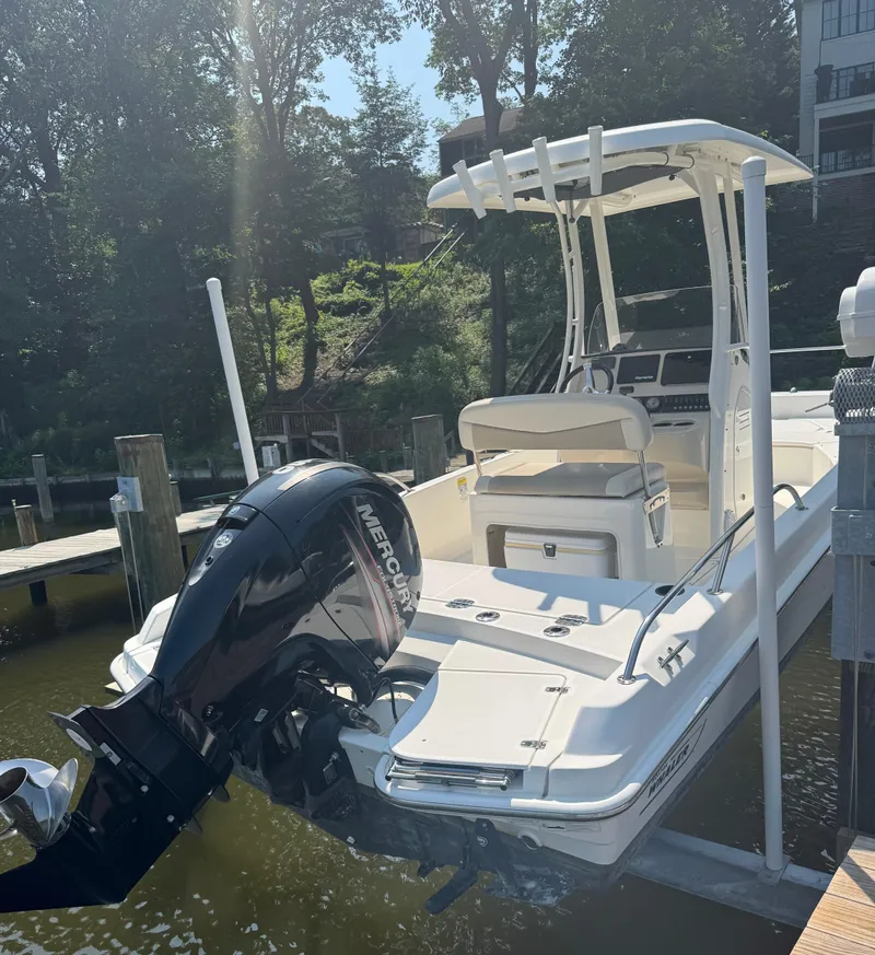 Slide: The Image of 2018 Boston Whaler 210 Dauntless boat docked with Mercury outboard engine. - 5