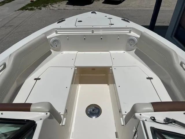 Slide: The Image of 2019 Cobia 240 Dual Console boat interior with spacious seating and storage compartments. - 3