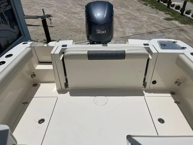 Slide: The Image of 2019 Cobia 240 Dual Console boat with Yamaha 300 outboard motor, rear seating view. - 6