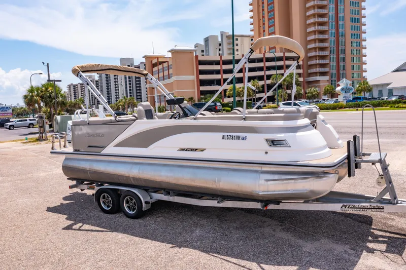 The Image of 2022 Silver Wave 2410 SW5 CLS pontoon boat on trailer, urban background. - 0