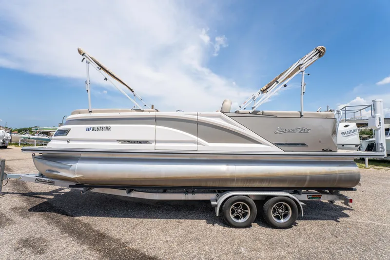 Slide: The Image of 2022 Silver Wave 2410 SW5 CLS pontoon boat on trailer under clear sky. - 10