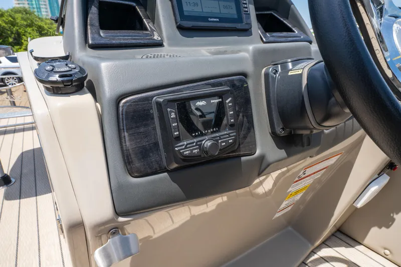 Slide: The Image of Control panel of 2022 Silver Wave 2410 SW5 CLS boat with audio system and steering wheel. - 24