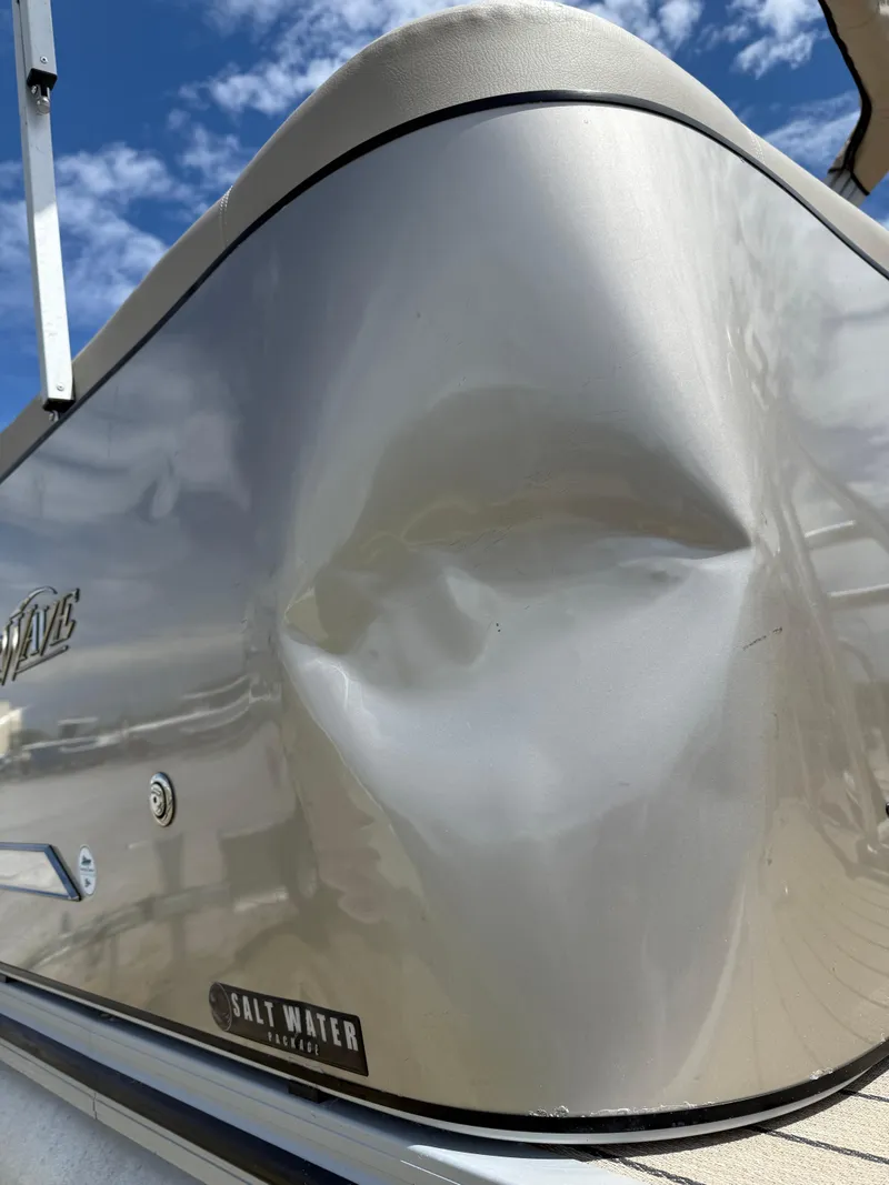 Slide: The Image of 2022 Silver Wave 2410 SW5 CLS boat with dented hull under blue sky. - 25