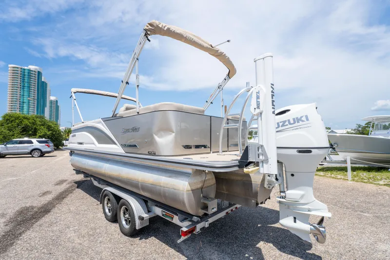 Slide: The Image of 2022 Silver Wave 2410 SW5 CLS pontoon boat on trailer, with Suzuki outboard motor. - 4