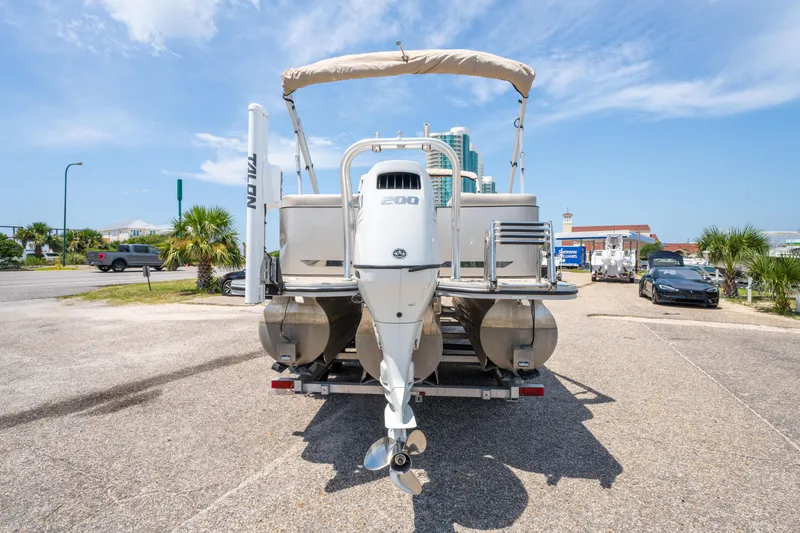 Slide: The Image of 2022 Silver Wave 2410 SW5 CLS pontoon boat on trailer, sunny day, parking lot. - 8