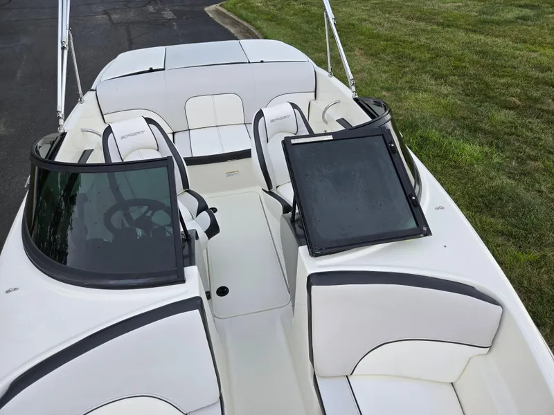Slide: The Image of 2012 Sea Ray 190 Sport boat interior with white seating and black accents. - 19