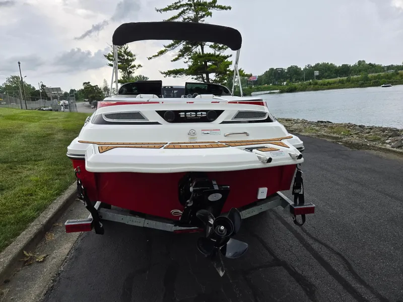Slide: The Image of 2012 Sea Ray 190 Sport boat on trailer by a riverside road. - 2