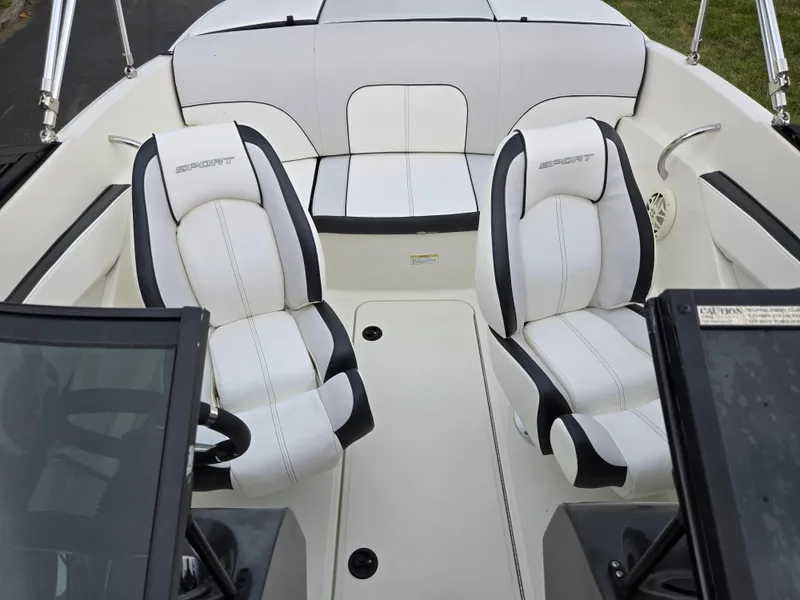 Slide: The Image of 2012 Sea Ray 190 Sport boat interior with white and black seating. - 20