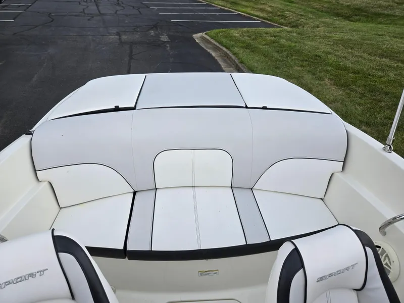 Slide: The Image of 2012 Sea Ray 190 Sport boat interior with white seating and black accents. - 21