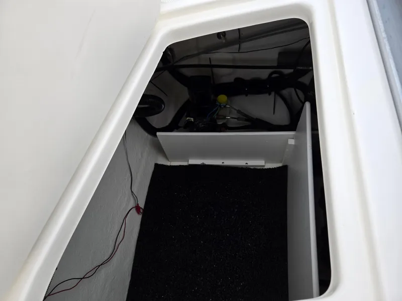 Slide: The Image of Storage compartment of a 2012 Sea Ray 190 Sport boat, showing interior details. - 23