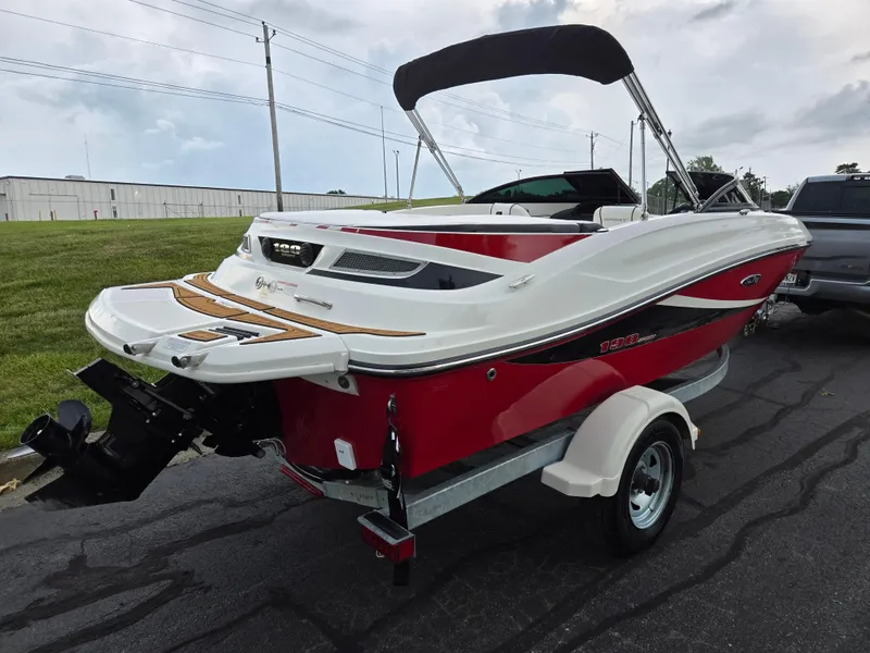 Slide: The Image of 2012 Sea Ray 190 Sport boat with red and white design on a trailer. - 3