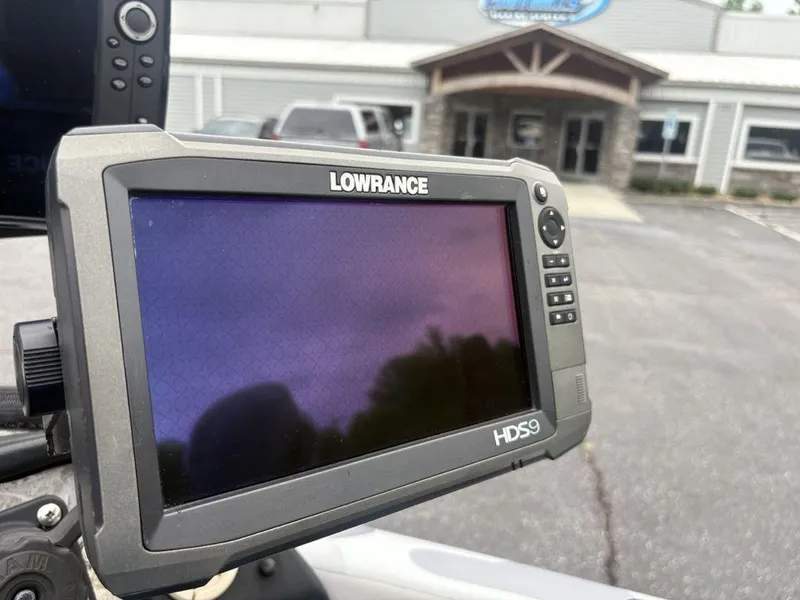 Slide: The Image of Lowrance HDS9 fishfinder on a 2008 Skeeter ZX200 boat, parked outside a building. - 11