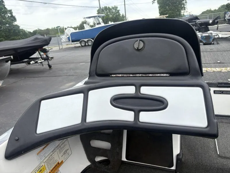 Slide: The Image of 2008 Skeeter ZX200 boat dashboard with storage compartment, parked in a lot. - 14
