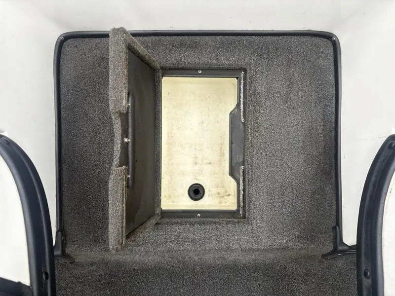 Slide: The Image of 2008 Skeeter ZX200 boat storage compartment with open lid, showing interior details. - 17