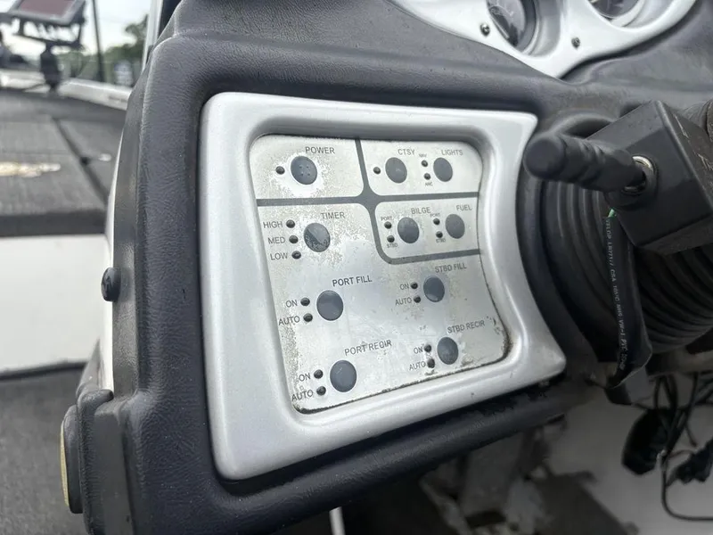 Slide: The Image of Control panel of a 2008 Skeeter ZX200 boat with various switches and dials. - 18