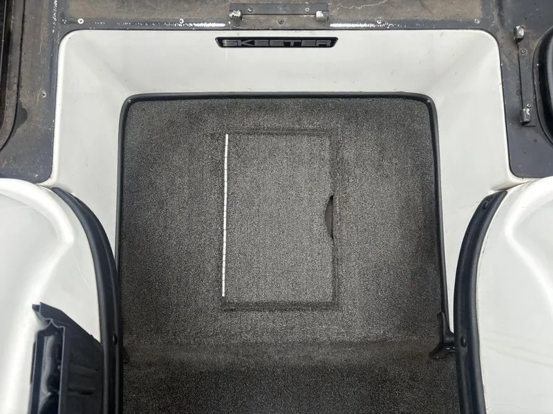 Slide: The Image of 2008 Skeeter ZX200 boat storage compartment with carpeted interior. - 19