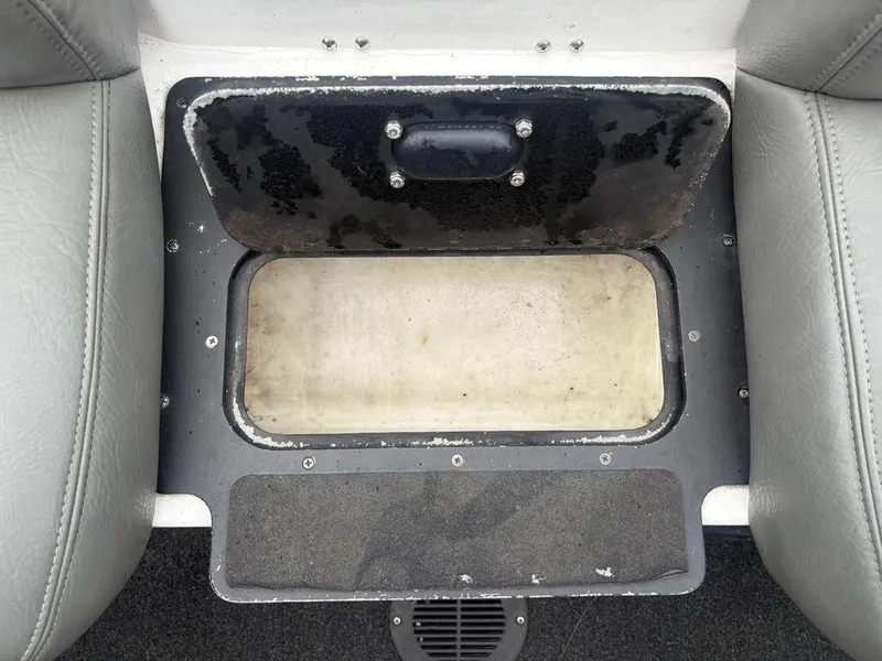 Slide: The Image of Storage compartment on a 2008 Skeeter ZX200 boat, featuring gray seating and black trim. - 21