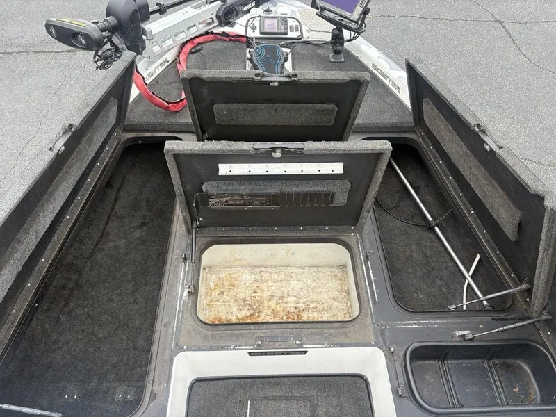 Slide: The Image of 2008 Skeeter ZX200 boat interior with open storage compartments and fishing equipment. - 8