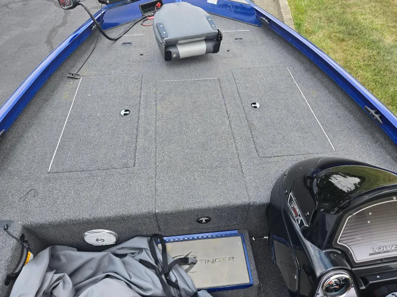 Slide: The Image of 2021 Lowe Stinger 188 boat interior with gray carpet and blue trim. - 13