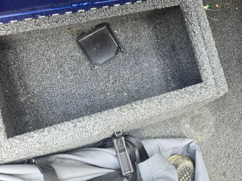 Slide: The Image of Carpeted storage compartment in a 2021 Lowe Stinger 188 boat. - 15