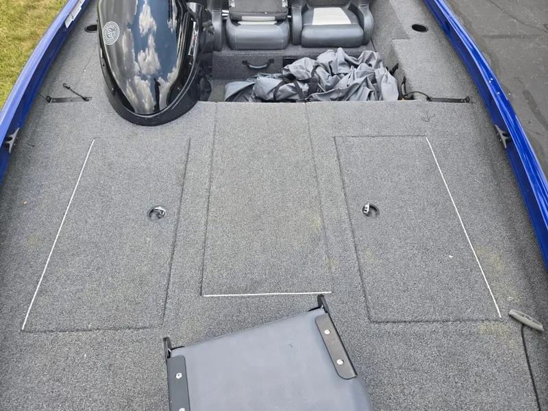 Slide: The Image of 2021 Lowe Stinger 188 boat interior with gray carpet and seating. - 17