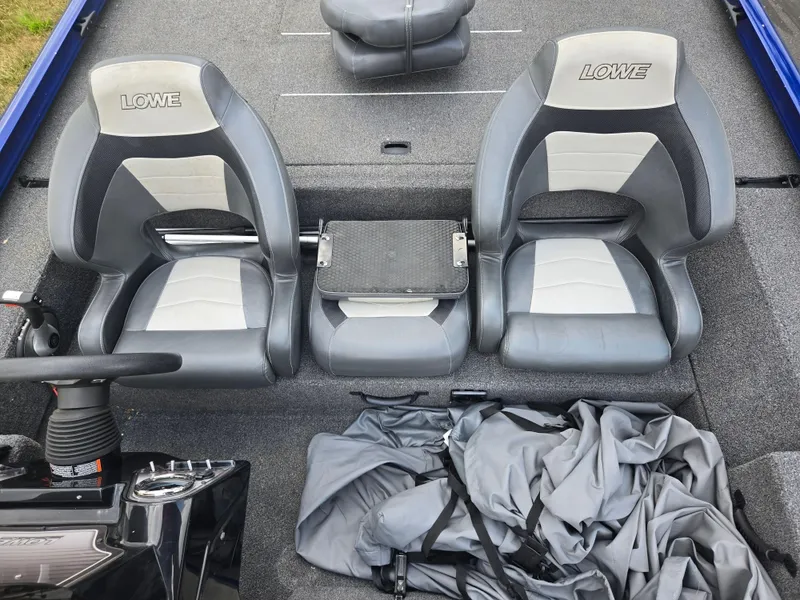 Slide: The Image of 2021 Lowe Stinger 188 boat interior with gray seats and steering console. - 19