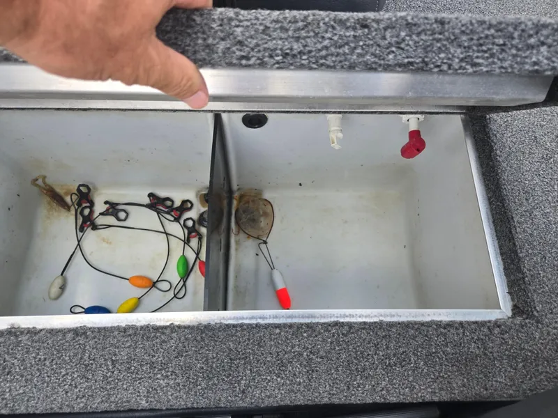 Slide: The Image of Open storage compartment in 2021 Lowe Stinger 188 boat with fishing gear inside. - 21