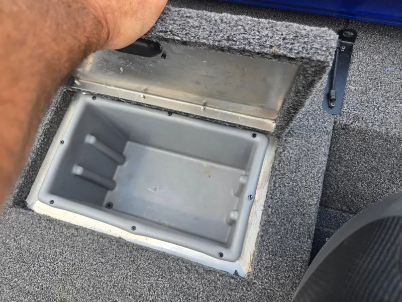 Slide: The Image of Open storage compartment in 2021 Lowe Stinger 188 boat, showing interior details. - 22