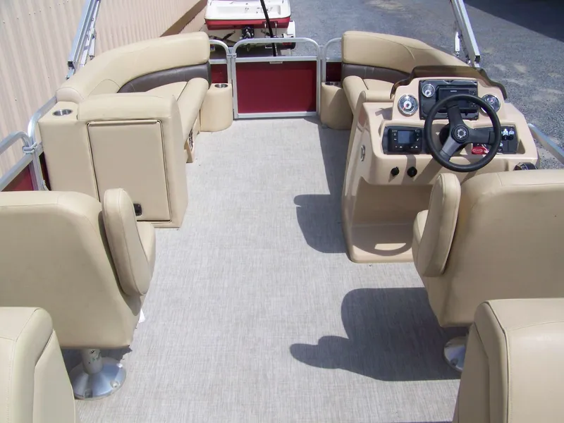 Slide: The Image of 2020 Avalon GS Quad Lounger boat interior with beige seating and steering console. - 11