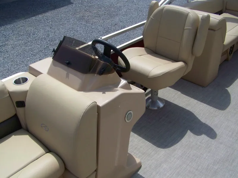 Slide: The Image of 2020 Avalon GS Quad Lounger boat interior with beige seating and steering console. - 5