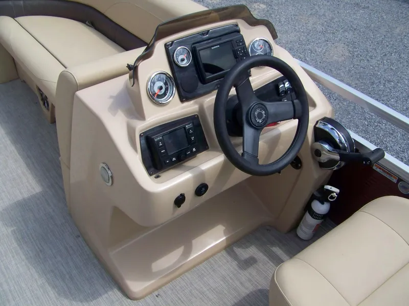 Slide: The Image of 2020 Avalon GS Quad Lounger boat dashboard with steering wheel and controls. - 7