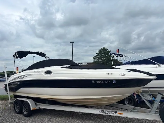 Slide: The Image of 2004 Sea Ray 240 Sundeck boat on trailer under cloudy sky. - 1