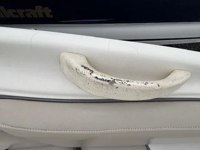 Slide: The Image of 2004 Sea Ray 240 Sundeck boat handle with visible wear and tear. - 15
