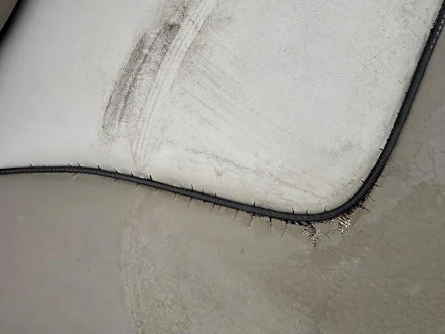 Slide: The Image of Close-up of a worn seat cushion on a 2004 Sea Ray 240 Sundeck boat. - 18